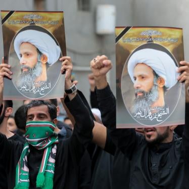 Men hold placards bearing portraits of a prominent Shia Muslim cleric, Nimr al-Nimr, whose execution sparked demonstrations in 2016 by the country's minority Shia citizens against systematic governmental discrimination. Some of the alleged child offenders currently on trial were accused of attending similar protests. 