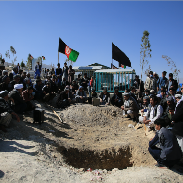 Afghan men bury a victim of the suicide attack that targeted a school  in Kabul, Afghanistan, October 25, 2020