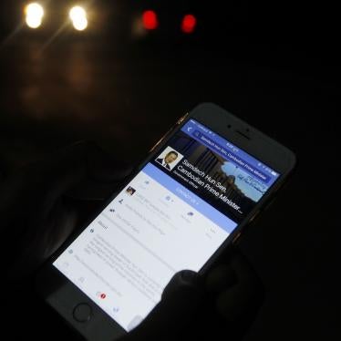 A man views Cambodian Prime Minister Hun Sen's Facebook page on his mobile phone in downtown Phnom Penh, Cambodia.