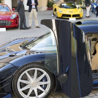 People looking at luxury cars owned by Teodoro Obiang, son of Equatorial Guinea's President Teodoro Obiang Nguema Mbasogo, before an auction of sales house Bonhams at the Bonmont Abbey Golf & Country Club near Geneva, Switzerland, September 29, 2019.