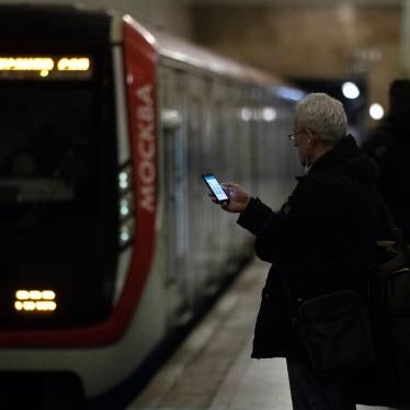 A man checks his smartphone while waiting to board a subway in Moscow, Russia, December 23, 2019. 