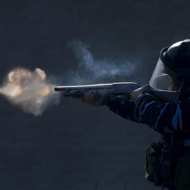 A police officer aims his weapon, as security forces fire tear gas and rubber bullets, during clashes with people after police broke up a squatters camp and evicted people living there in Guernica, Buenos Aires province, Argentina, Thursday, on Oct. 29, 2020.