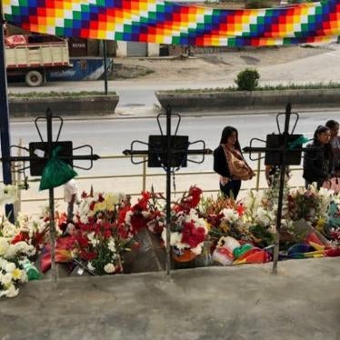 People visit a makeshift memorial on February 2, 2020 at the site where protestors were killed in Sacaba, Bolivia, on November 15, 2019.