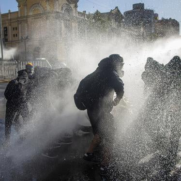 Police car throws water at protesters during protests against the government of Sebastián Piñera, in Santiago de Chile, on November 27, 2020.
