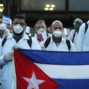 Medics and paramedics from Cuba pose upon arrival at the Malpensa airport of Milan, Italy, Sunday, March 22, 2020.