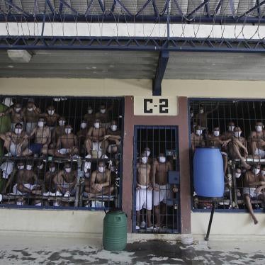 Detainees, wearing protective face masks, look out from behind bars during a media tour of the prison in Quezaltepeque, El Salvador, Friday, Sept. 4, 2020.