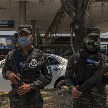 Honduran soldiers wearing facemasks guard the entrance to the city of San Pedro Sula during the coronavirus crisis on April 17, 2020.
