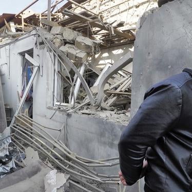 A man walks past a shop damaged in an attack by Azerbaijani forces on Stepanakert, Nagorno-Karabakh.