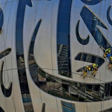 Workers clean the exterior of the Museum of the Future, currently under construction, in Dubai on November 19, 2020.