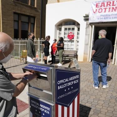 A voter drops their ballot off during early voting, October 19, 2020, in Athens, Georgia. 