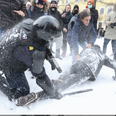A policeman detains a man while protesters try to help him, during a protest against the jailing of opposition leader Alexei Navalny in St. Petersburg, Russia, Sunday, Jan. 31, 2021.