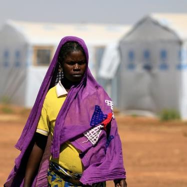 A pregnant woman walks in a camp for internally displaced people in Dori, Burkina Faso, November 24, 2020. 