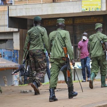 Ugandan police and security forces chase people off the streets, having cleared a stand of motorcycle taxis after all public transport was banned for two weeks to slow the spread of the new coronavirus, in Kampala, Uganda, March 26, 2020