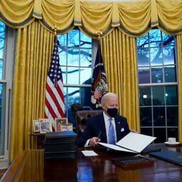 President Joe Biden signs his first executive orders in the Oval Office of the White House in Washington, January 20, 2021. 