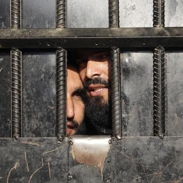 Taliban prisoners look out a prison door in the city of Jalalabad, August 3, 2020.