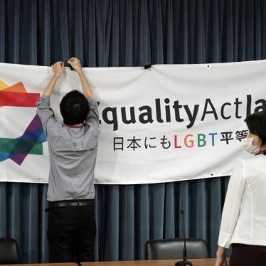 A staff member adjusts a banner for a press conference to launch international signature campaign for the enactment of the "LGBT Equality Law" as a legacy of the Tokyo Olympics Thursday on October 15, 2020, in Tokyo.