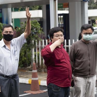 Activist Somyot Pruksakasemsuk, left Parit Chiwarak, and Arnon Nampha raise a three-finger salute, a symbol of resistance, as they arrive at Criminal court in Bangkok, Thailand, Tuesday, Feb. 9, 2021.