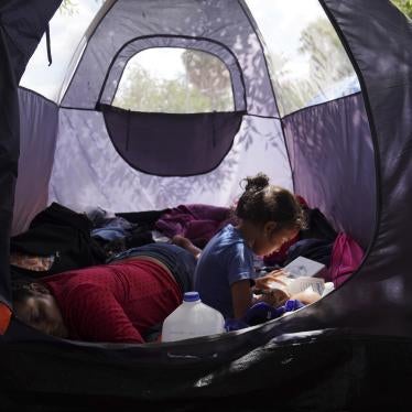 Asylum seeker Yareni, age five, flips through the pages of a book in an encampment where she lives near the Gateway International Bridge in Matamoros, Mexico. 