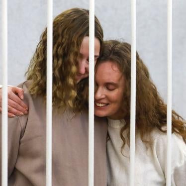 Journalists Ekaterina Andreyeva (Bakhvalova), right, and Daria Chultsova embrace inside the defendants' cage during a court hearing in Minsk, Belarus, February 9, 2021. 