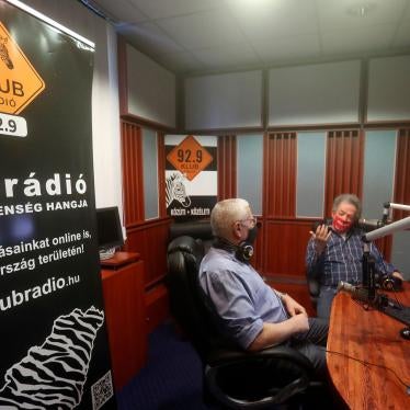 Klubradio's director and CEO Andras Arato, right, talks to colleague Milhaly Hardy in the studio of Klubradio in Budapest, Tuesday, Feb. 9, 2021.