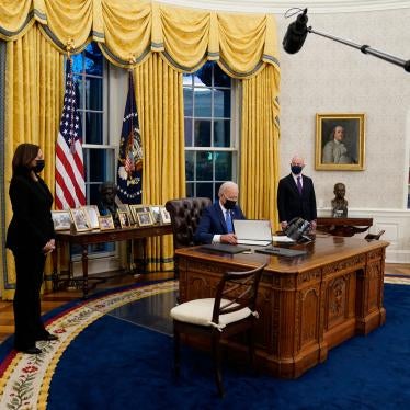 Vice President Kamala Harris, left, and Secretary of Homeland Security Alejandro Mayorkas, right, watch as President Joe Biden signs an executive order on immigration in the Oval Office of the White House in Washington, February 2, 2021.