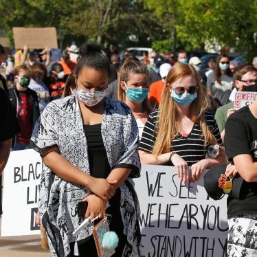 People bow their heads during a rally to protest the death of George Floyd, June 3, 2020, in Stillwater, Oklahoma.