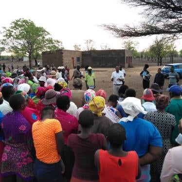 Staff from the Masvingo Centre for Research Advocacy and Development (MACRAD Trust) consult with members of the Chilonga community in Chiredzi. 