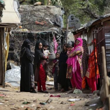 Rohingya refugees stand outside their makeshift camp on the outskirts of Jammu, India, March 7, 2021. 