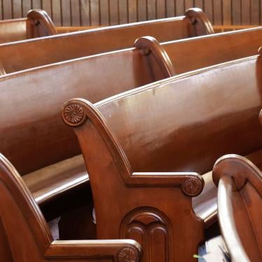 Curved pews are seen inside of a church. 