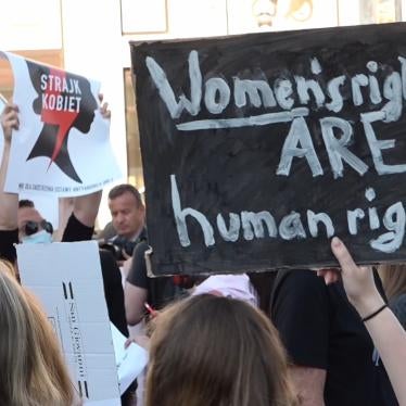 Protesters for Women's rights in Poland raise signs