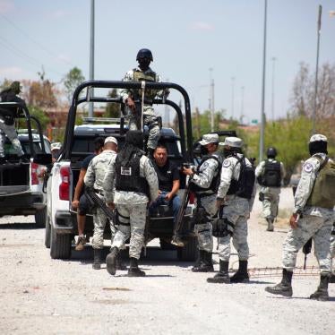 Mexican National Guard members arrest a migrant who tried crossing the Río Bravo in Ciudad Juárez,
