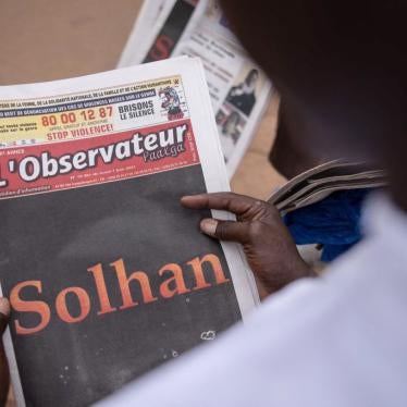A man reads the L'Observateur Paalga newspaper in Ouagadougou on June 7, 2021, about the attacks that happened in Solhan. 