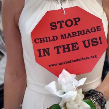 A demonstrator wearing a bridal gown takes part in a protest urging legislators to end Massachusetts child marriage