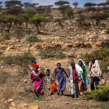 People walk from a rural area towards a food distribution site near the town of Agula, in Tigray, Ethiopia