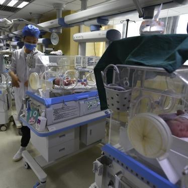 A nurse checks the conditions of babies at a maternity hospital in Fuyang in central China's Anhui Province on Sunday, April 25, 2021. 