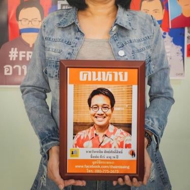 Sitanun Satsaksit holds a portrait of her brother, Wanchalearm, who was forcibly disappeared while living in exile in Cambodia on June 4, 2020. 