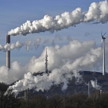 A Uniper coal-fired power plant and a BP refinery steam beside a wind generator in Gelsenkirchen, Germany on Jan. 16, 2020. © 2020 Martin Meissner/AP Photo