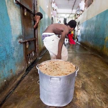 A detainee pulls a large stock pot filled with rice and beans during lunch inside the National Penitentiary in downtown Port-au-Prince, Haiti, on Febuary. 13, 2017. 