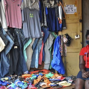 Grace Twisimire, 25, sits in her shop selling clothes and plastic shoes in Kampala, Uganda, June 20, 2020.