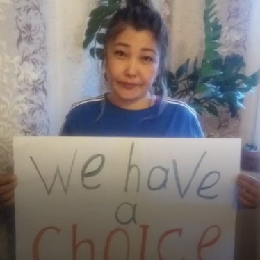 Photo of woman holding sign saying, "We have a choice."