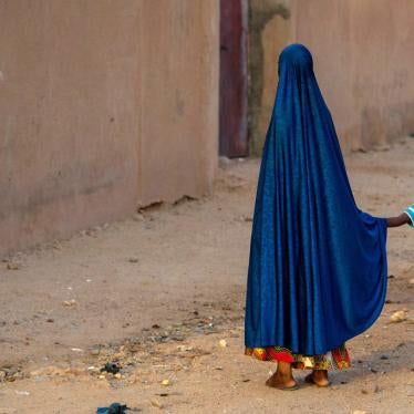 A girl holds the hand of a boy in Agadez, Niger on October 9, 2018.