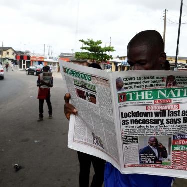 A man reading the newspaper "The Nation"