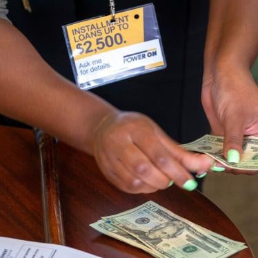 A manager of a financial services counts cash being paid to a client as part of a loan in Ballwin, Missouri on August 9, 2018