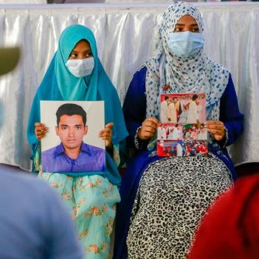 Children hold the picture of their fathers as they join in an event to mark the International Day of the Disappeared in Dhaka, Bangladesh on August 30, 2021.