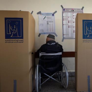 A man in a wheelchair at a voting booth