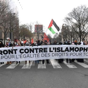 Protesters hold a banner at a demonstration against a bill dubbed as "anti-separatism" and islamophobic in Paris, France on March 21, 2021.