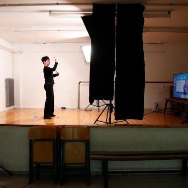 A sign language interpreter records sign language lessons that are broadcast on public television, at an elementary school in Athens, Friday, Nov. 20, 2020. 