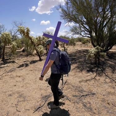 Alyssa Quintanilla, part of the Tucson Samaritans volunteer group, carries a cross, May 18, 2021, to be installed near Three Points, Arizona. The cross will be installed in the desert to commemorate the death of a migrant there. 