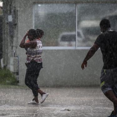Haitians deported from the United States leave Toussaint Louverture International Airport under a rain shower in Port au Prince, Haiti on September 19, 2021.
