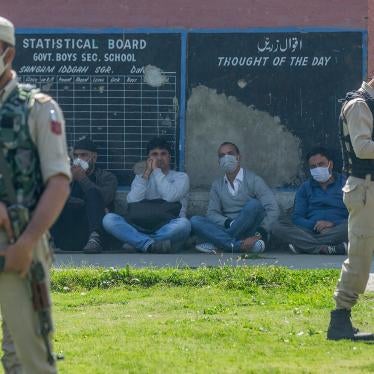 Indian paramilitary soldiers stand guard next to teachers at a government school where suspected militants fatally shot two teachers on the outskirts of Srinagar, India, October 7, 2021. 